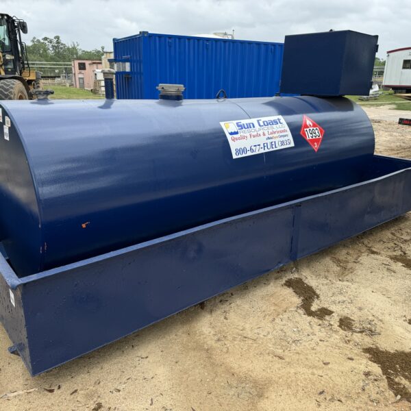 1743642058749364746_tempImage - Big River Trenchless & GeoServices Large blue cylindrical fuel/storage tank on a concrete base at a construction site, with safety labels and a blue control box on top colors blue and gray surroundings.