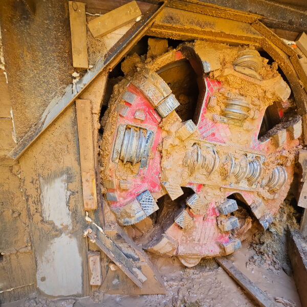 WHCRWA-Contract-64-Img9 - Big River Trenchless & GeoServices Mud-covered, circular metal frame with broken red tile fragments and wooden supports in a collapsed structure.